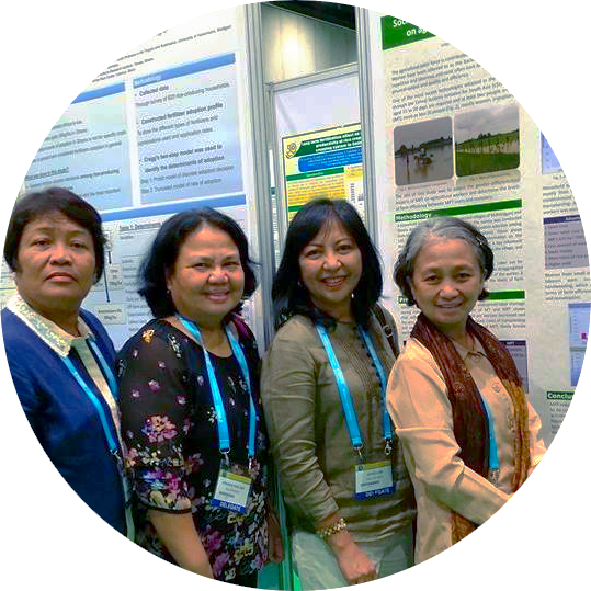 Joyce with colleagues in front of a research poster