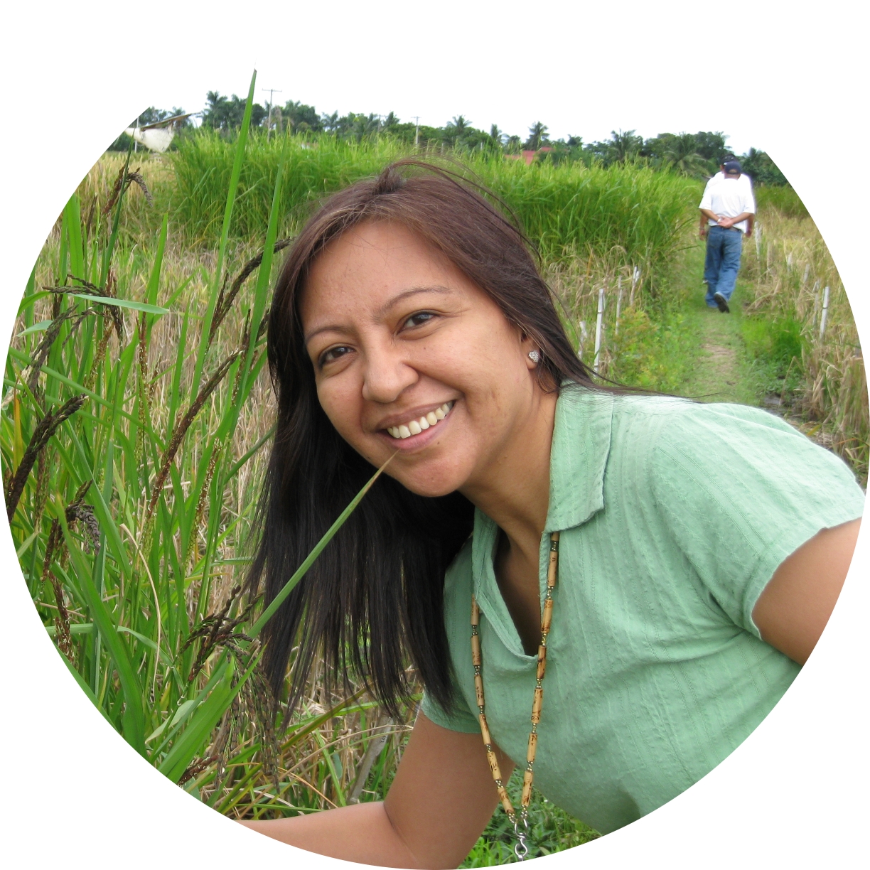 Joyce posing next to a rice plant